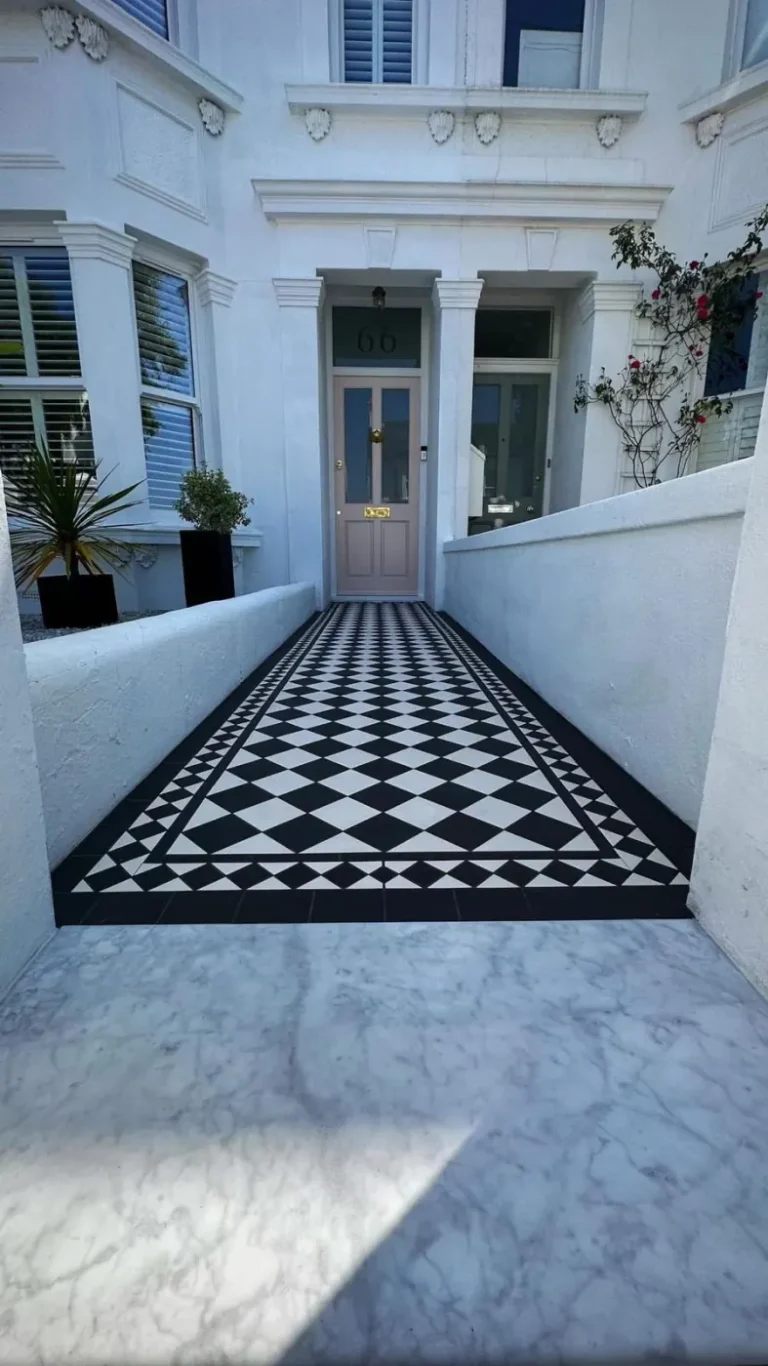Geometric tiled front path with black border outside a period London house