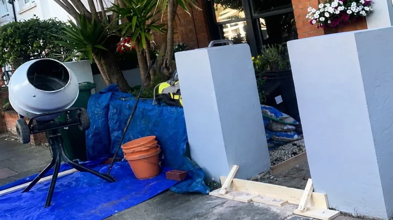 Front path entrance prepared for porcelain tile installation with shuttering, tools and materials in place.