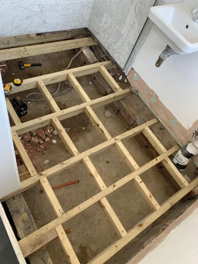 Bathroom suspended timber floor opened up with new timber joist framework ready for reinforcement.